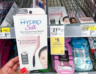 hand holding a Schick Hydro Silk dermaplanning wand box next to sales tag