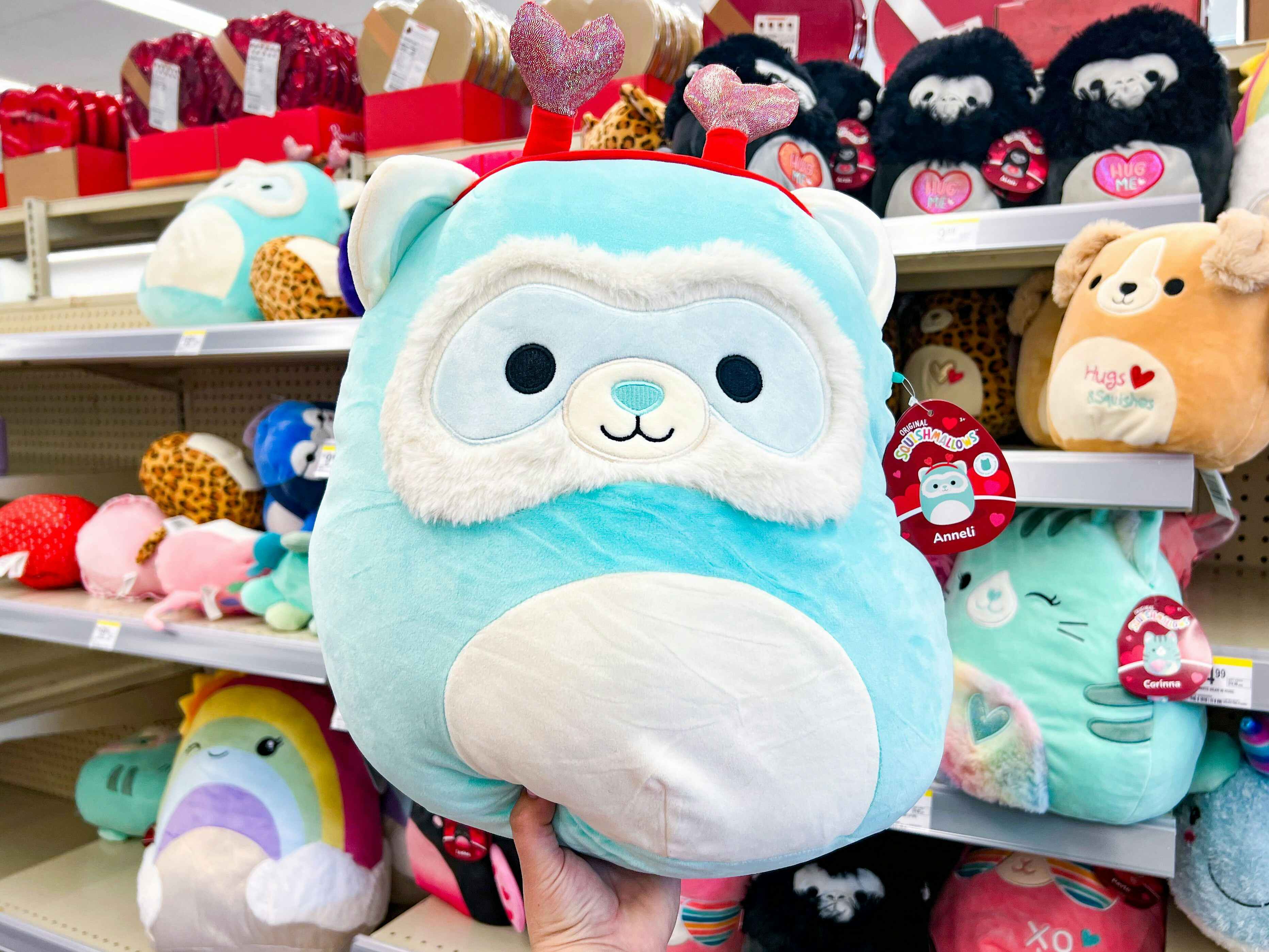 Someone holding up an Anneli Valentine's Day Squishmallow in Walgreens