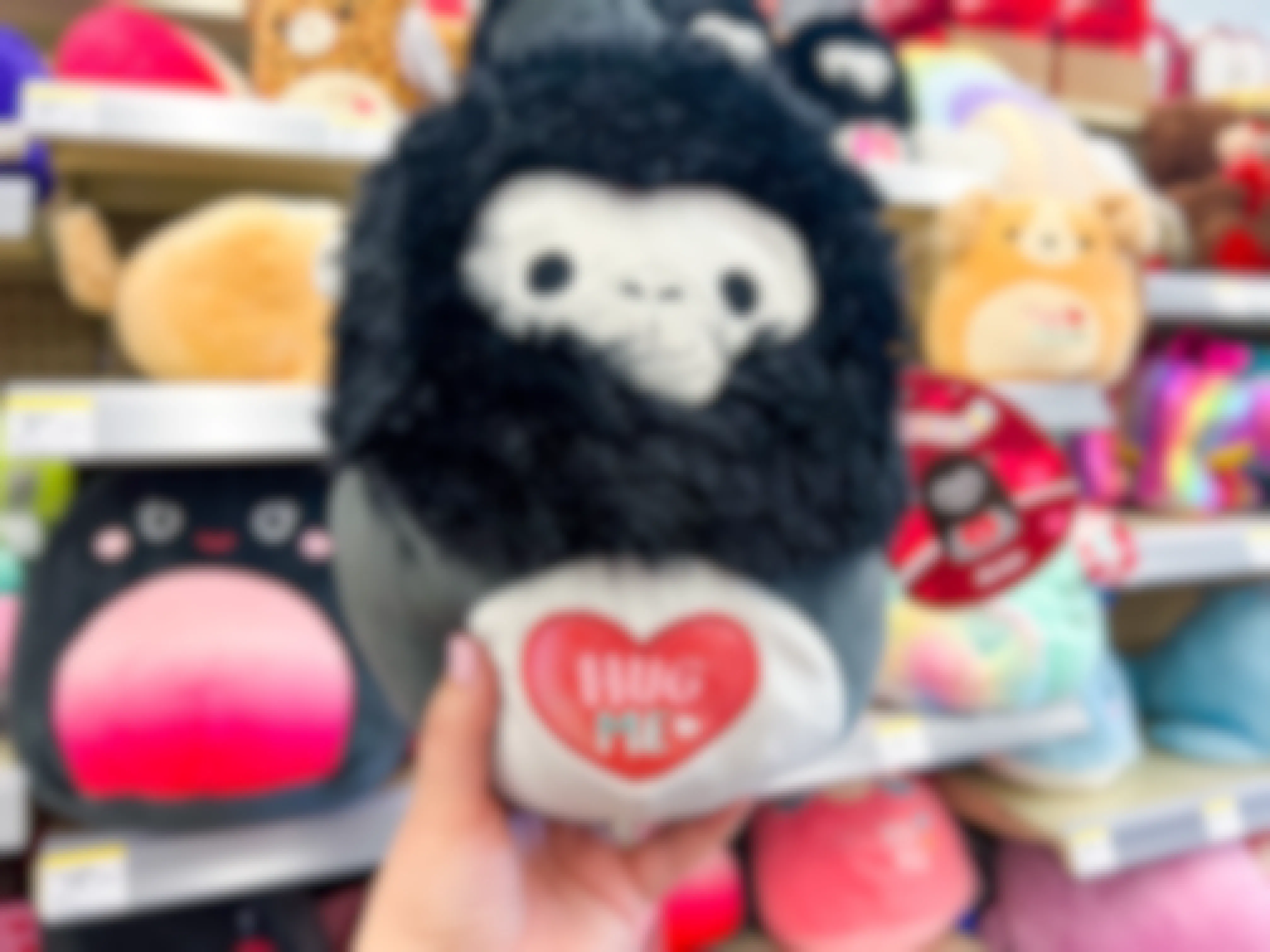 Someone holding up an Aron Valentine's Day Squishmallow in Walgreens