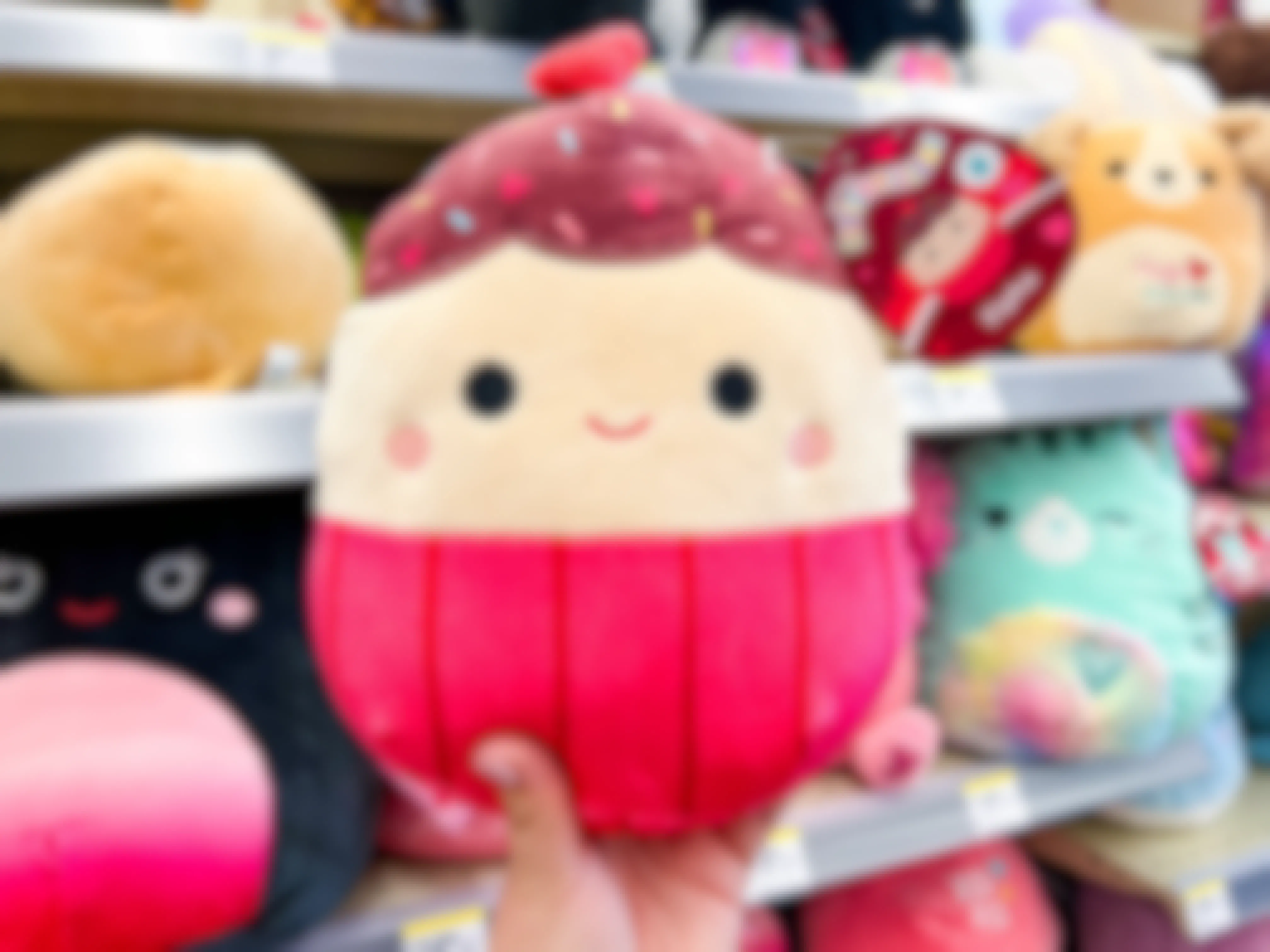 Someone holding up an Elpha Valentine's Day Squishmallow in Walgreens