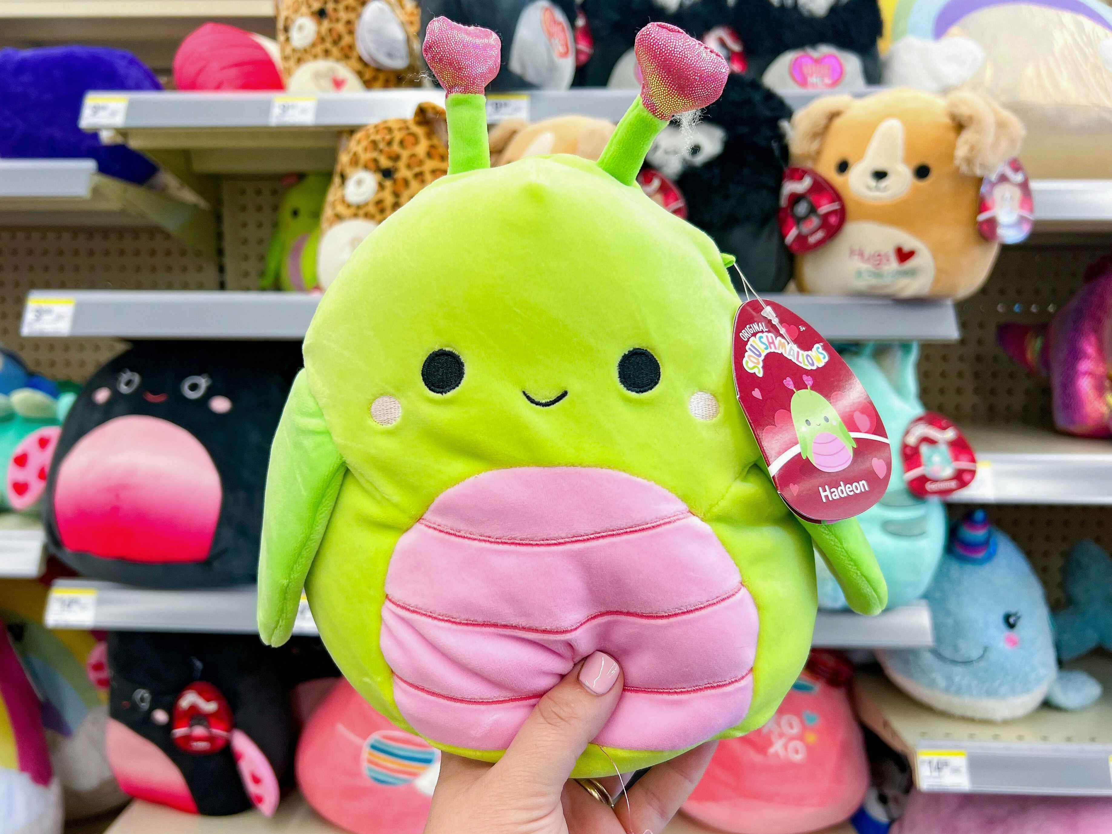 Someone holding up a Hadeon Valentine's Day Squishmallow in Walgreens