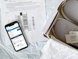 shoes in box next to return label and phone return screenshot