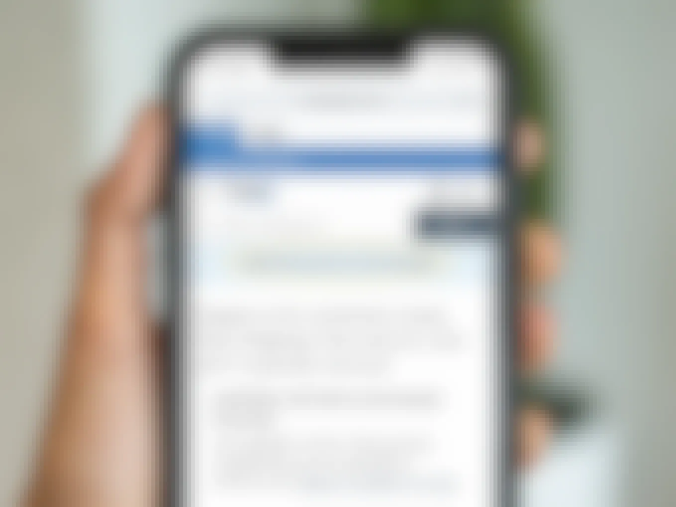 person holding iphone showing zappos 365-day return policy screenshot