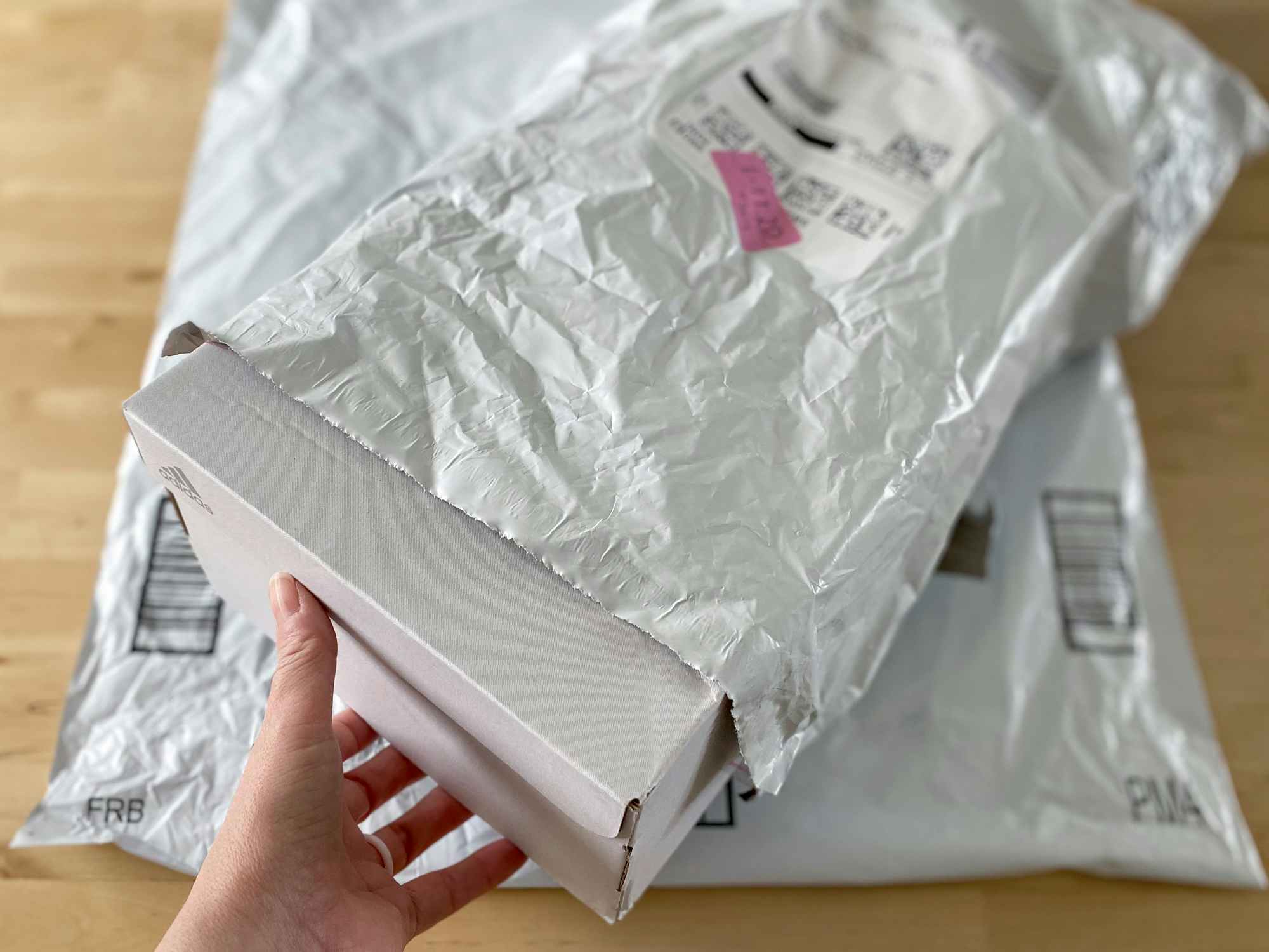 person placing shoe box into original packaging