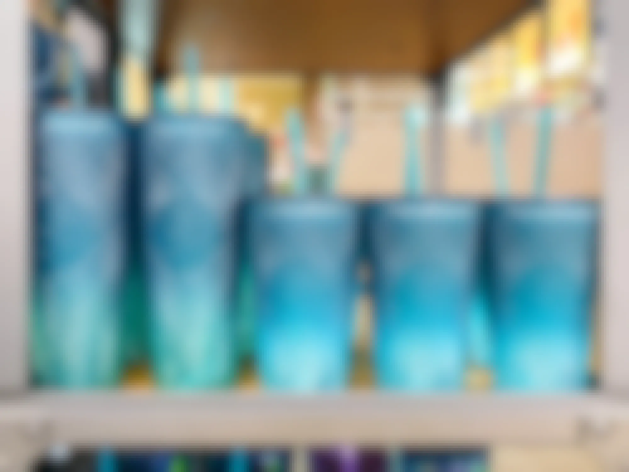 two sizes of starbucks spring 2023 teal ombre tumblers on display