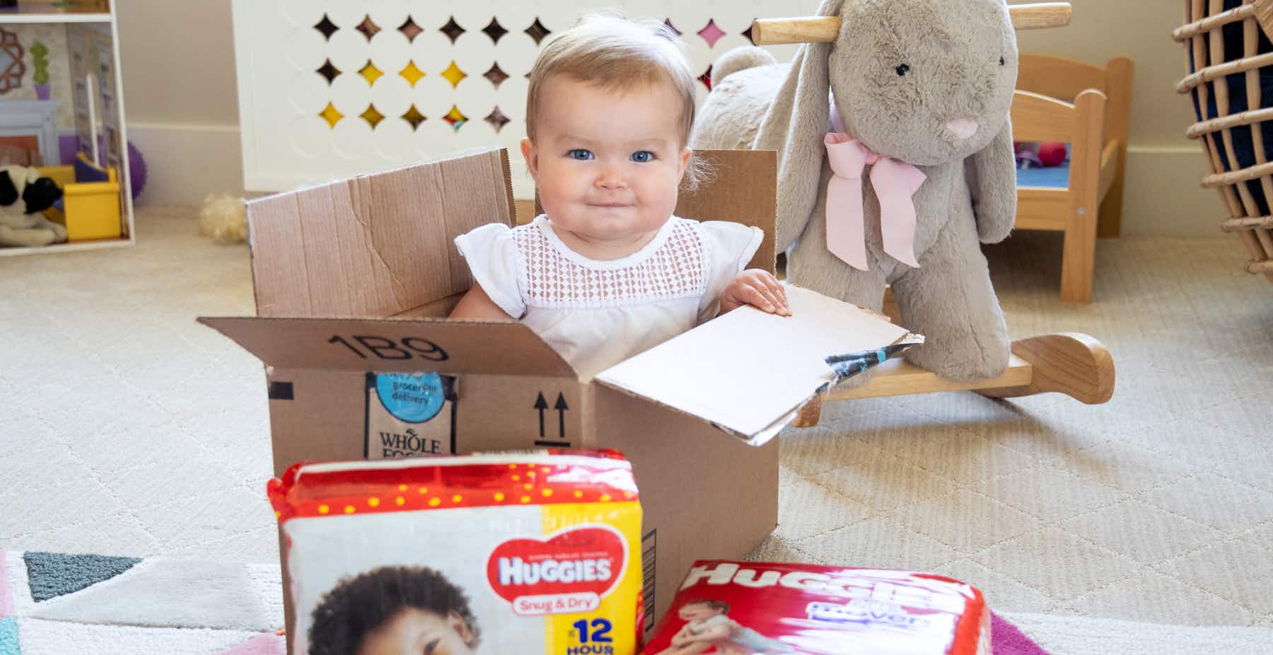 baby in nursery sitting in Amazon box