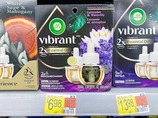 An Airwick Vibrant refill pack sitting on a store shelf.