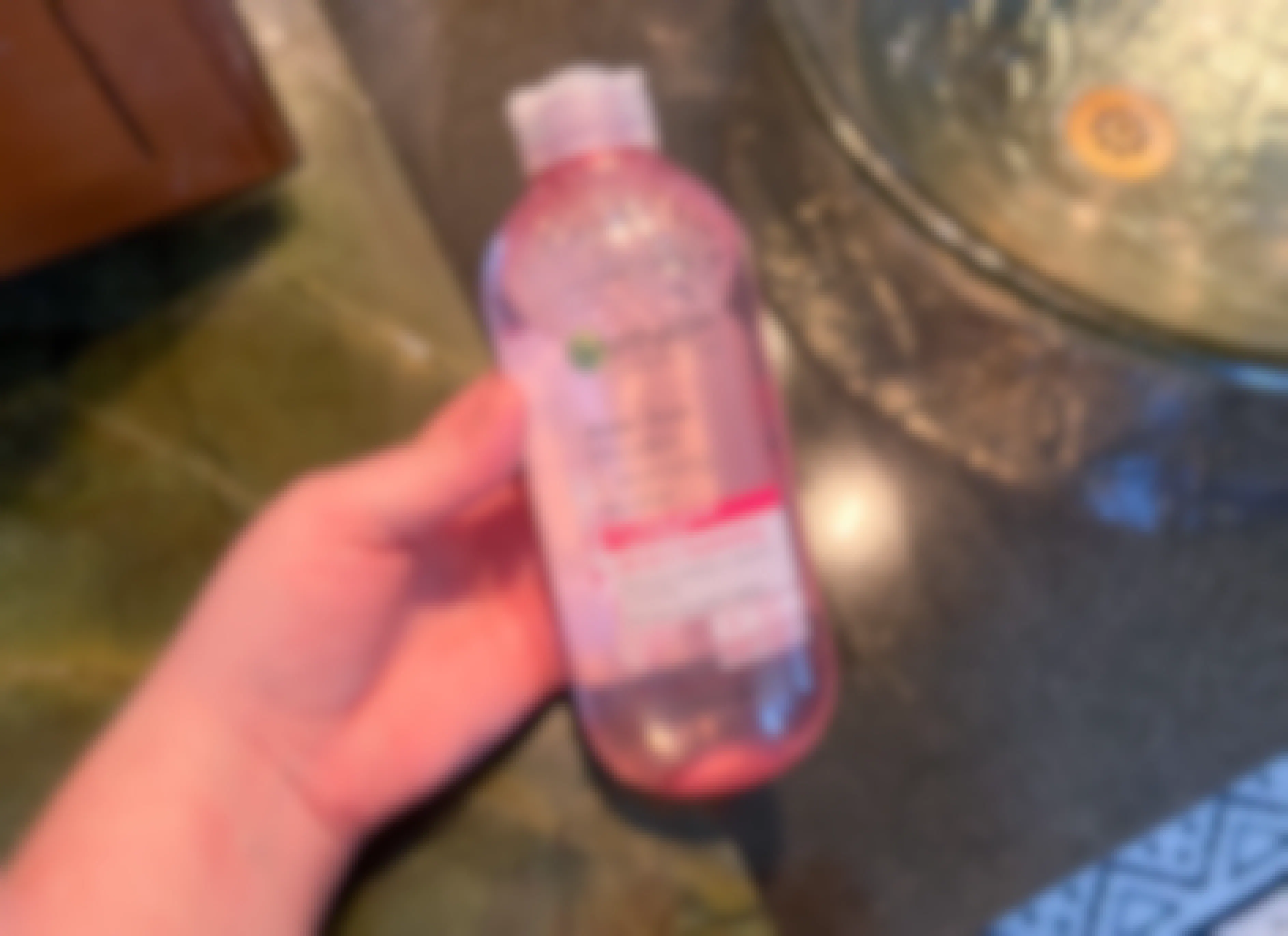 hand holding a bottle of garnier micellar cleansing water