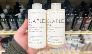 hand holding olaplex shampoo and conditioner