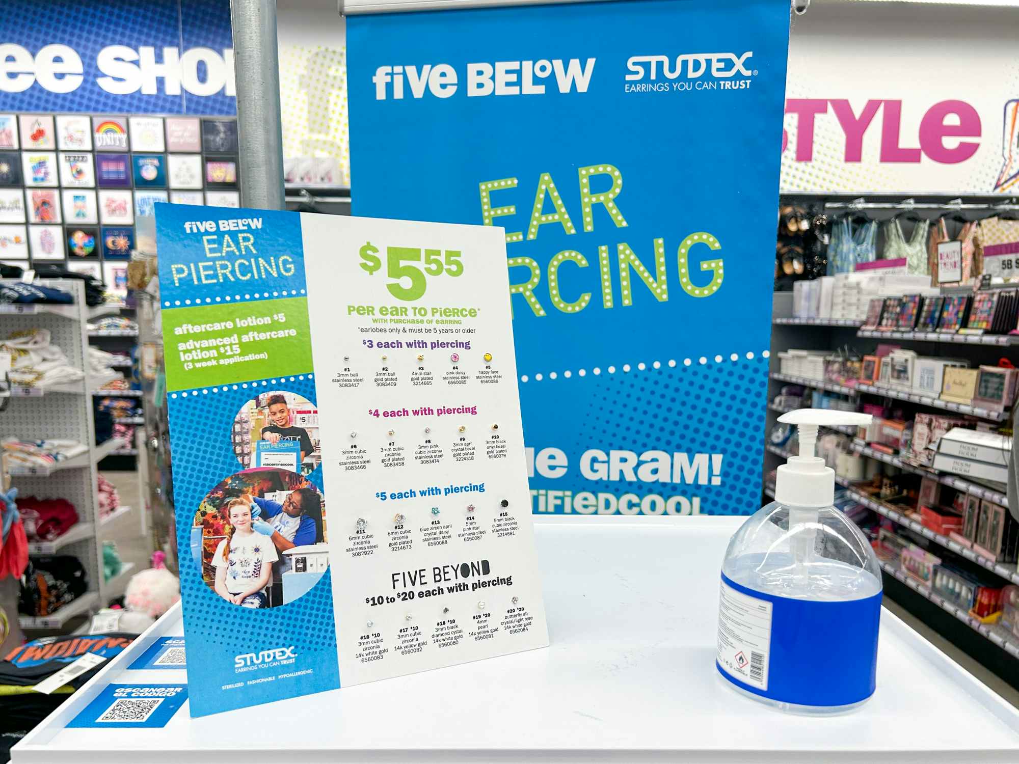 The ear piercing station inside Five Below with a sign of prices for earrings and hand sanitizer