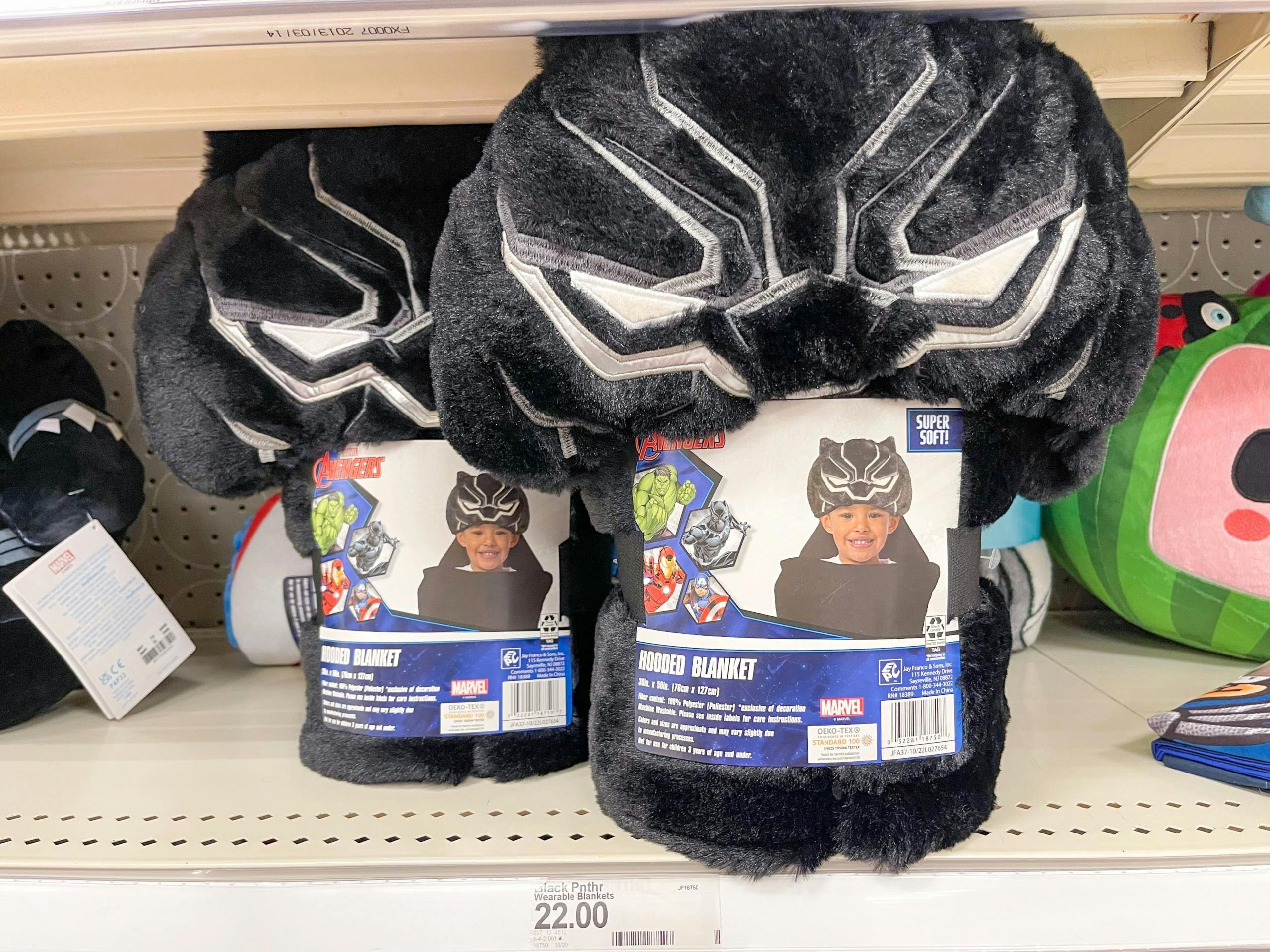 Two Black Panther hooded towels sitting on a store shelf above a price sticker.