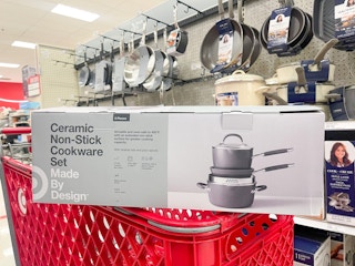 A Ceramic non-stick cookware set sitting atop a shopping cart.