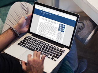 a person looking at the coffee mate settlement page on their macbook