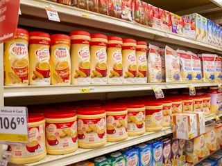 Shelves of Coffee Mate powder creamers in a store