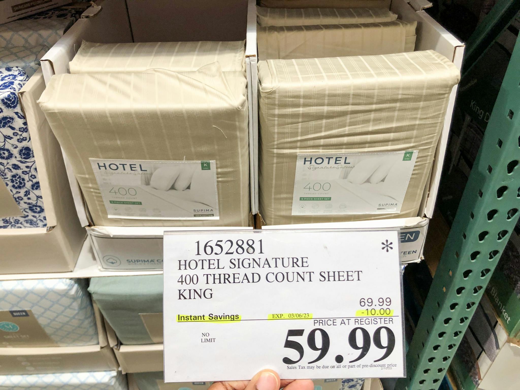 hand holding a price sign for 59.99 sheets