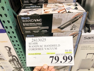 hand holding a 79.99 sign for the shark wandvac