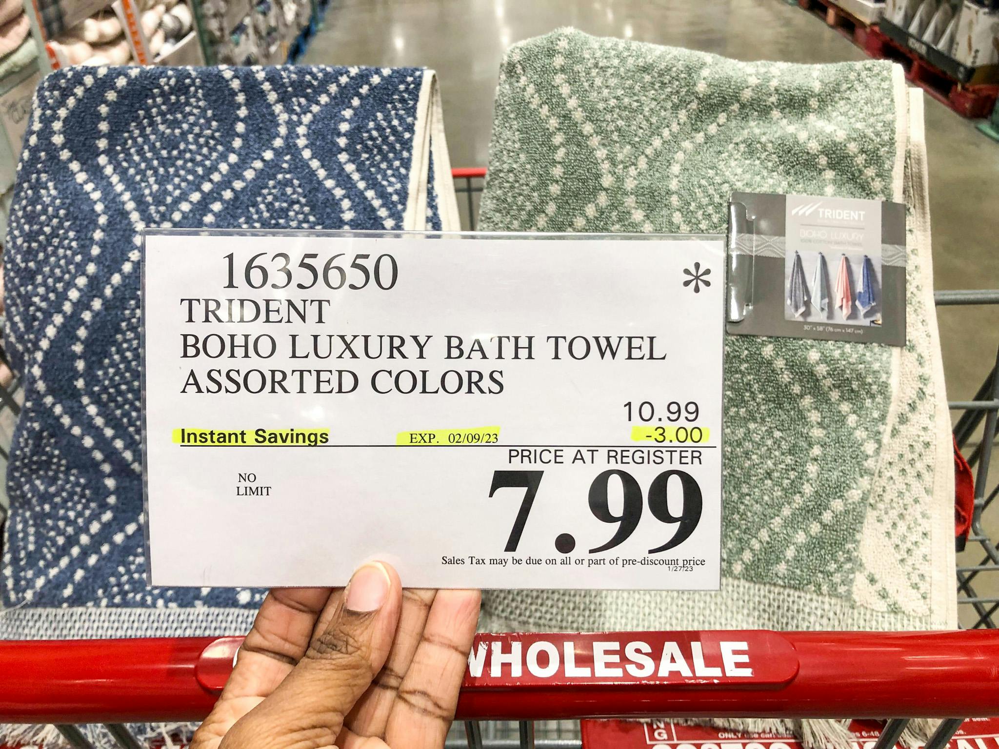 hand holding a sign for 7.99 bath towels