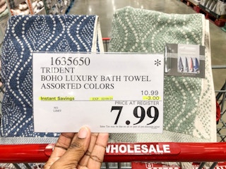 hand holding a sign for 7.99 bath towels