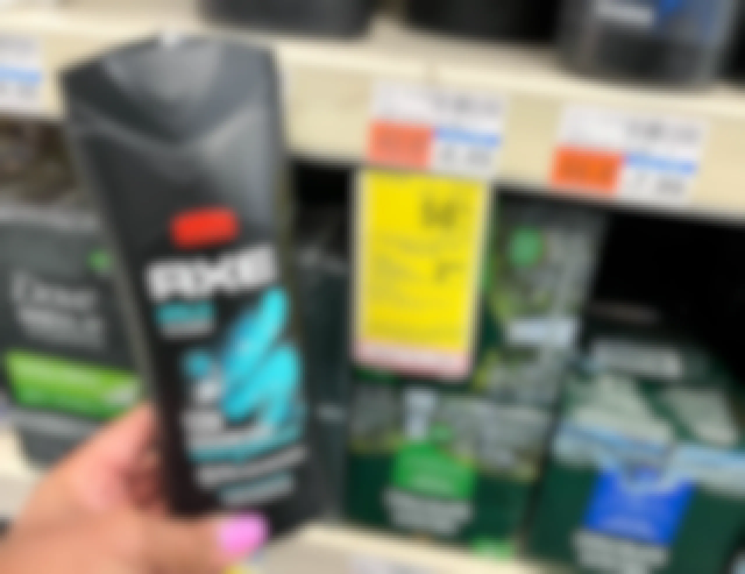 hand holding Axe body wash next to sales tag