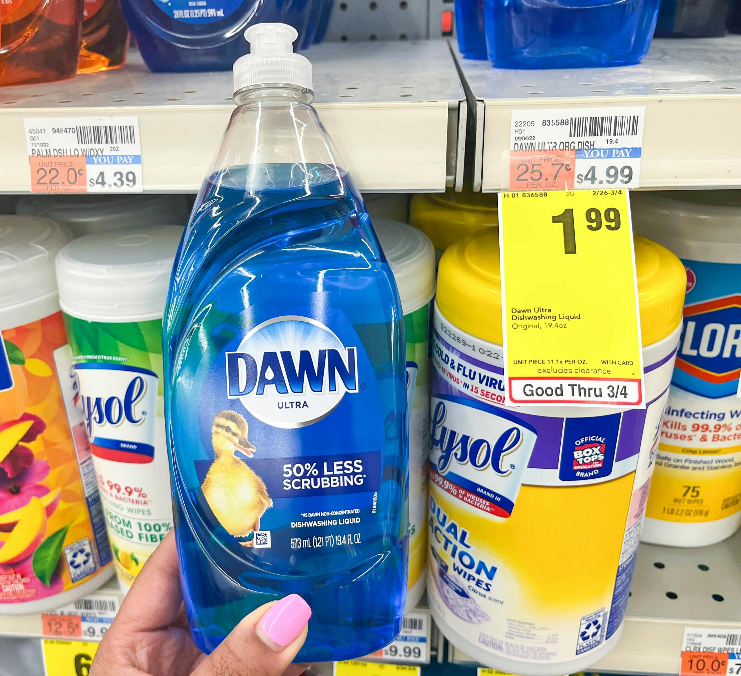 hand holding bottle of Dawn dish liquid next to sales tag