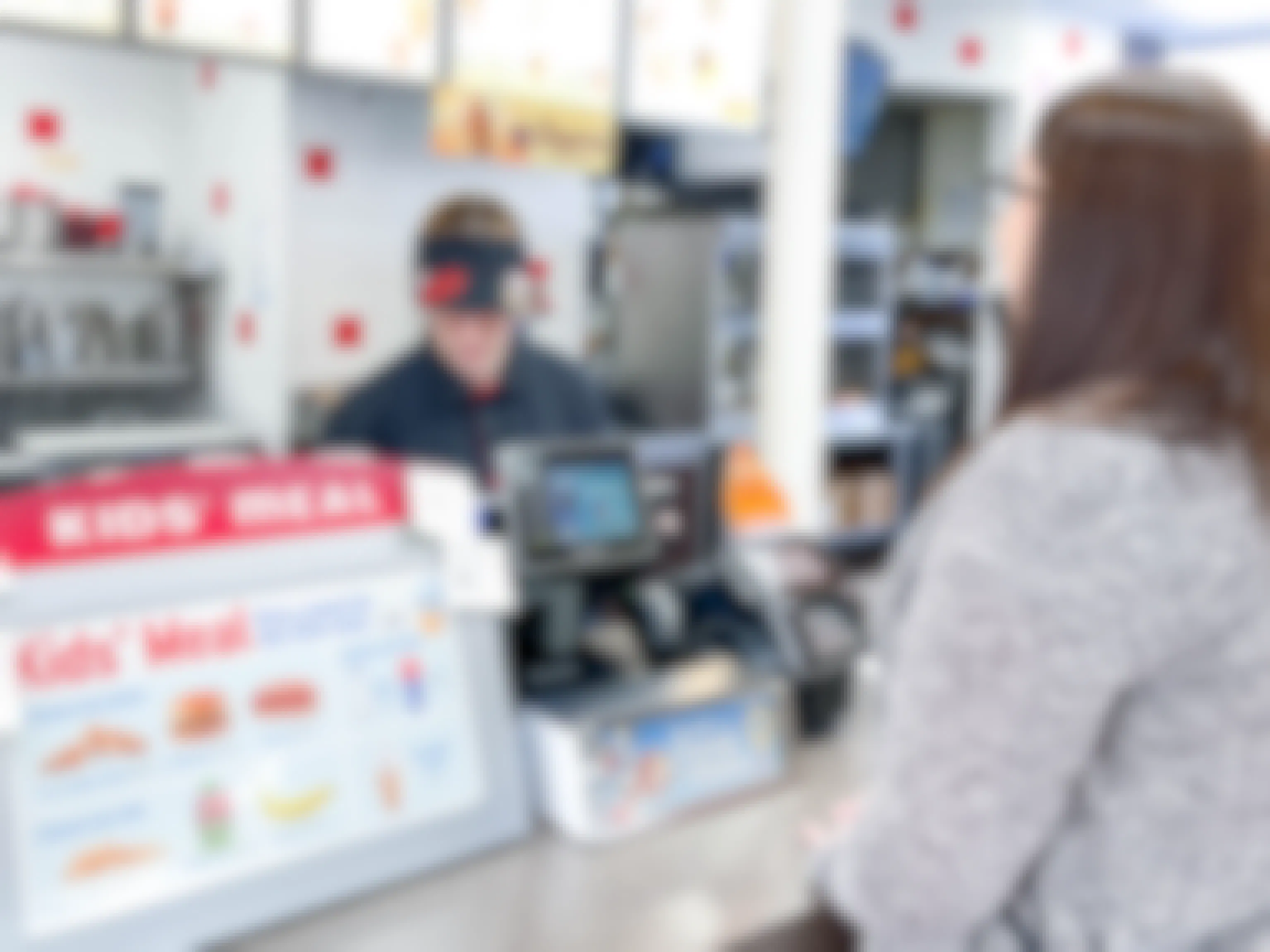 a person ordering at dairy queen at a register 