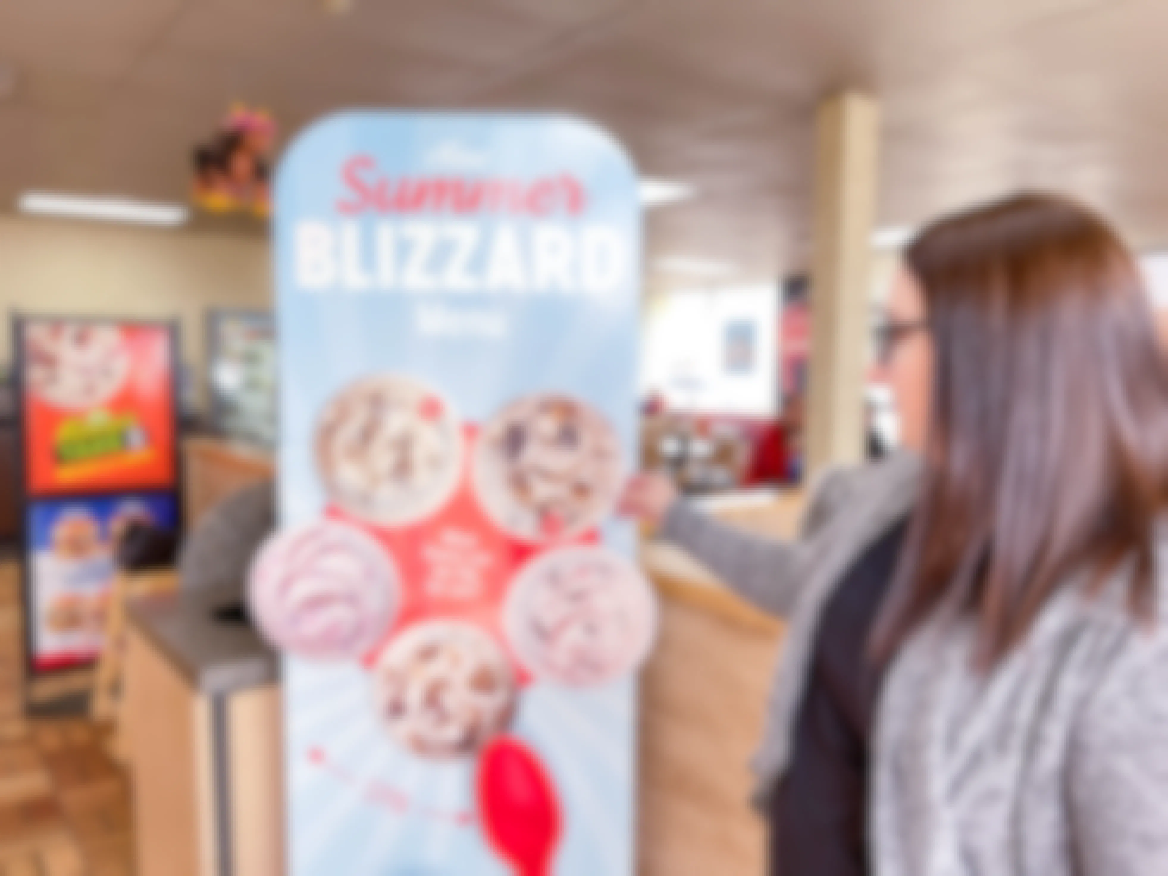 a person about to spin the dairy queen blizzard sign wheel 