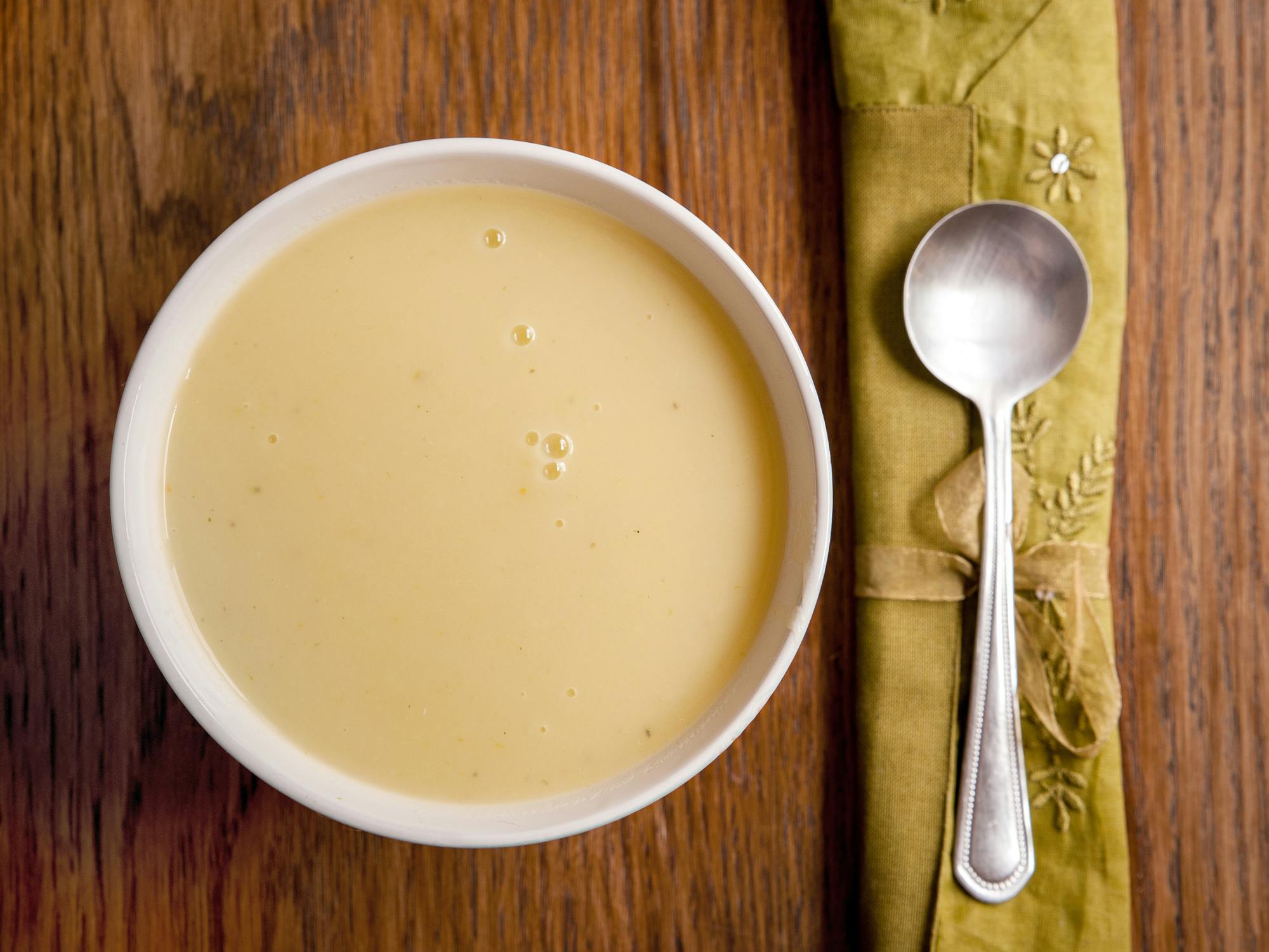 potato soup on table with spoon and napkin
