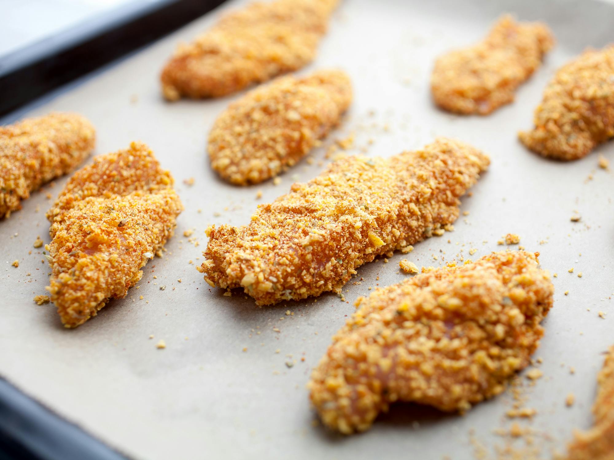 chicken strips breaded with ritz crackers on pan