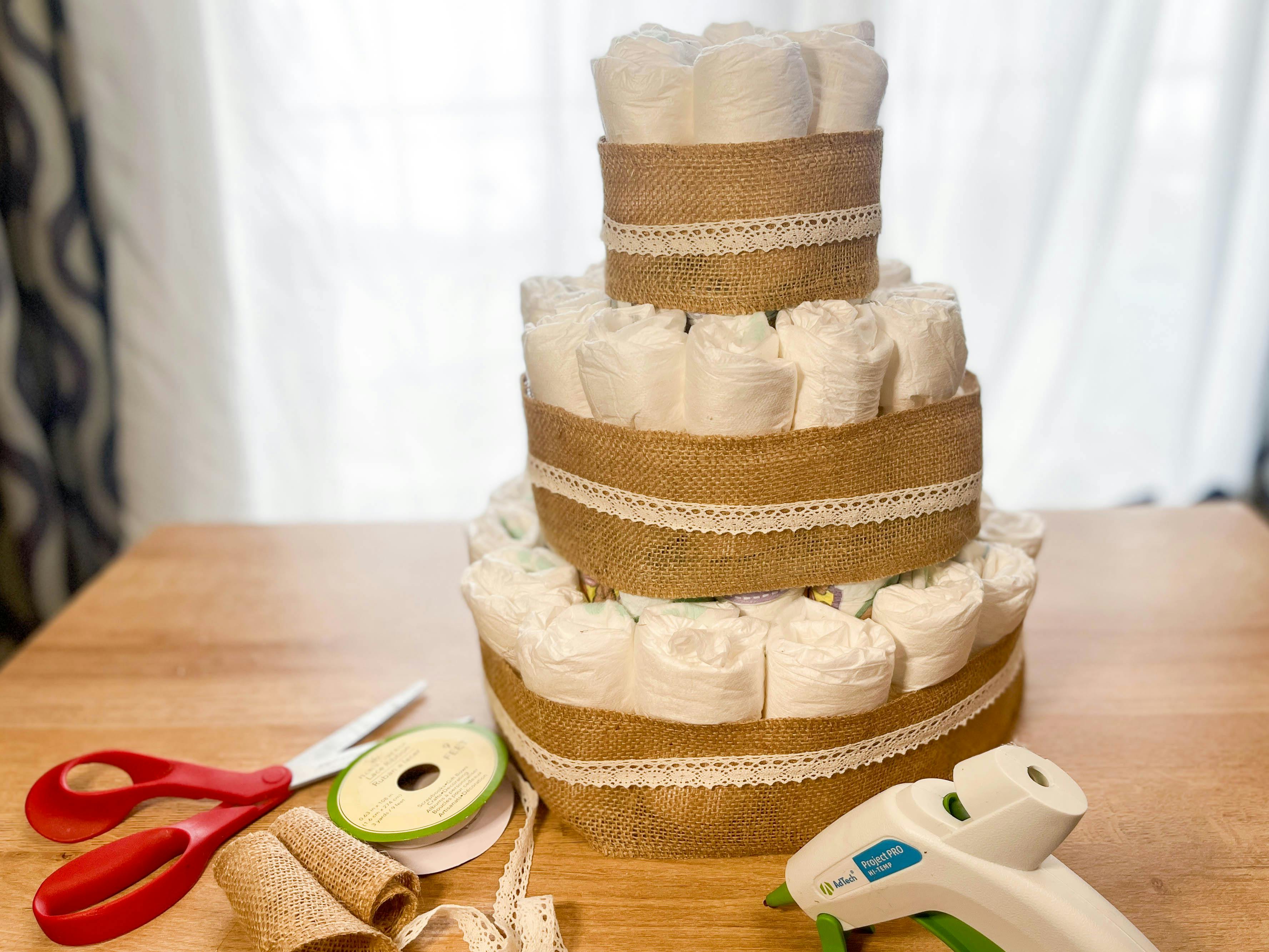 a top view of a diy diaper cake being made 