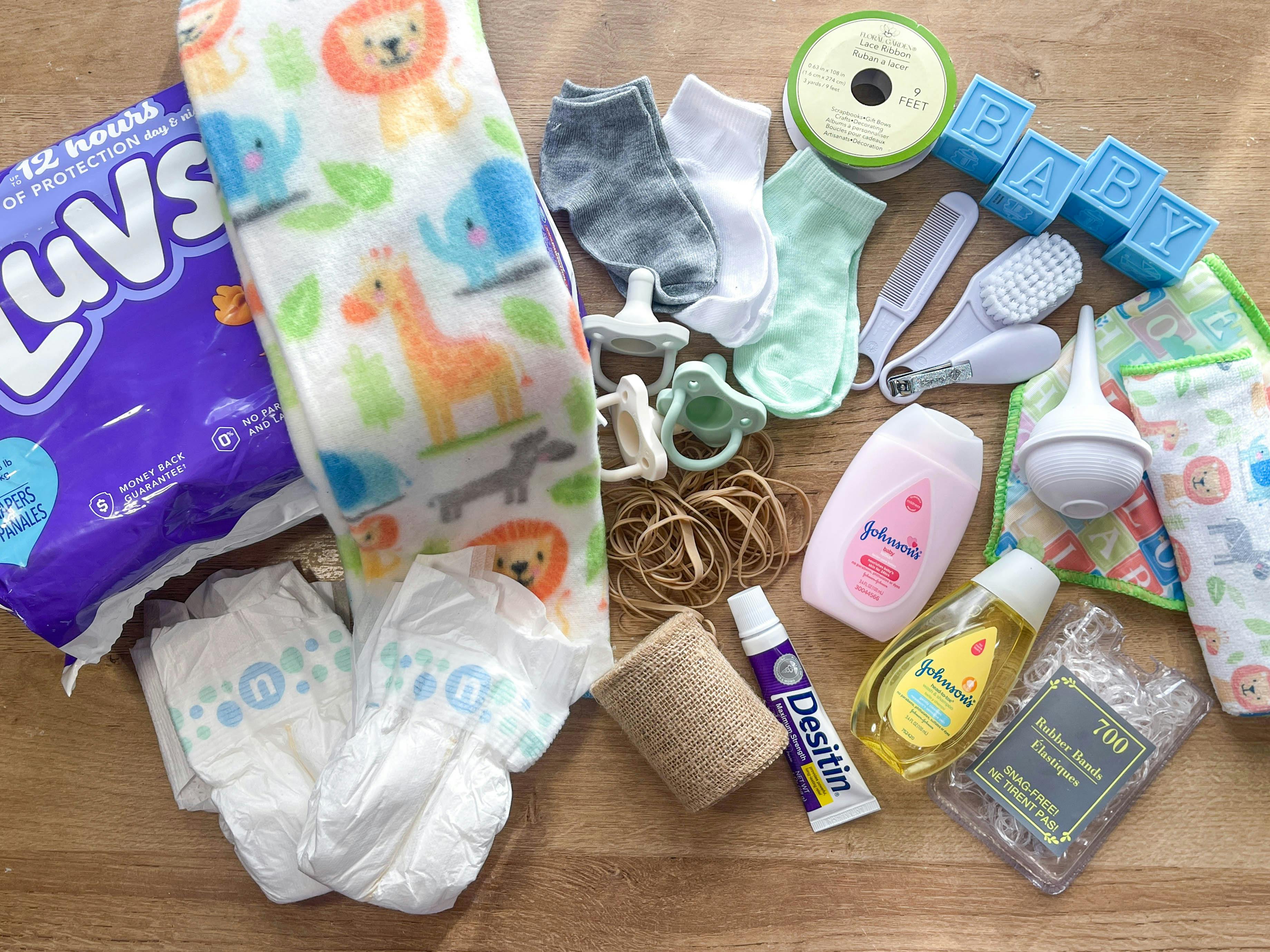 items to make a diy diaper cake sitting on a table 