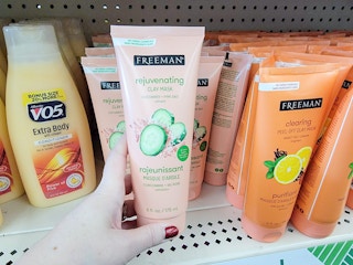 hand holding a clay facial mask bottle