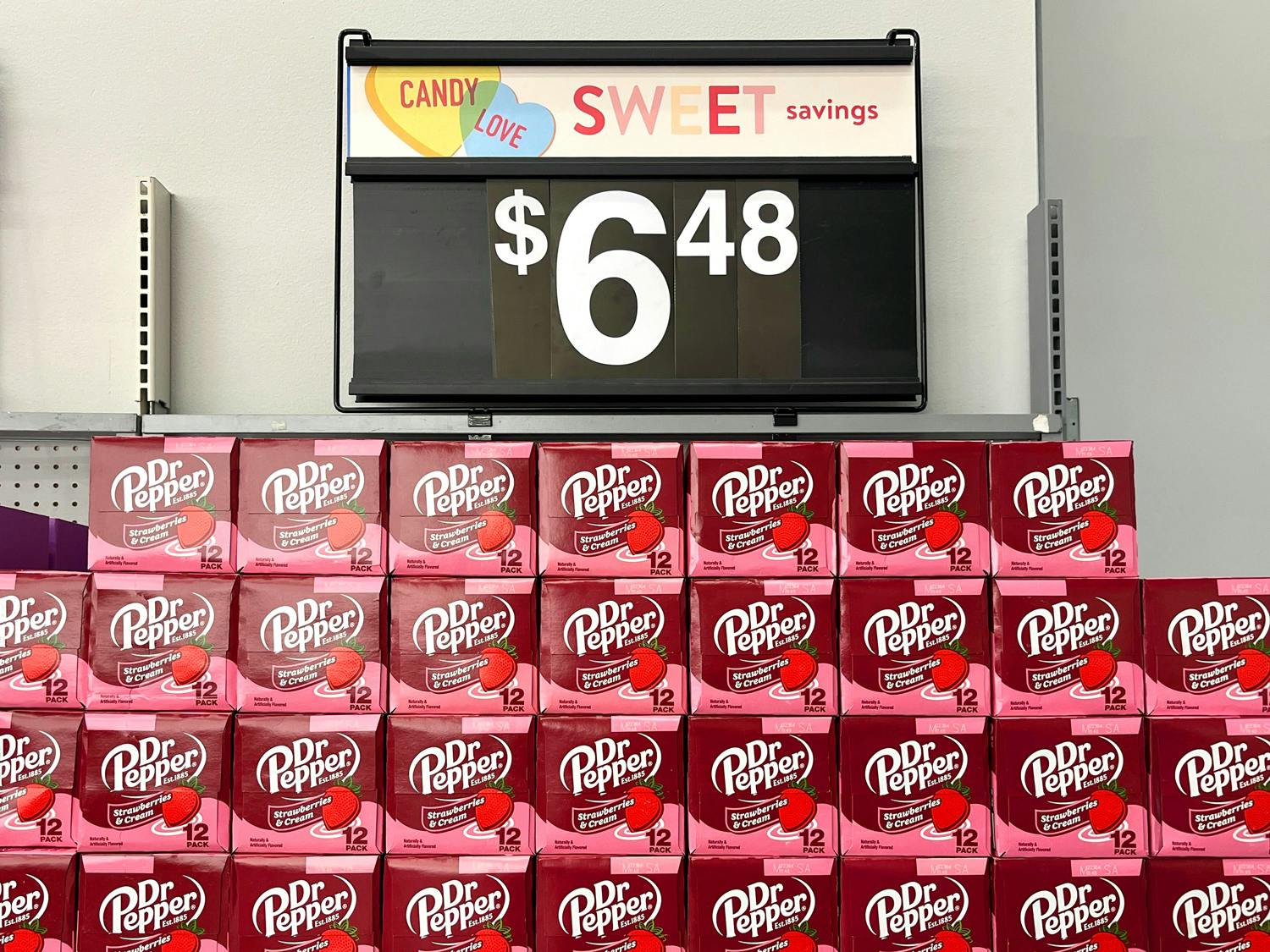 The new Dr Pepper Strawberries and Cream flavored soda on a shelf with a price sign for $6.48