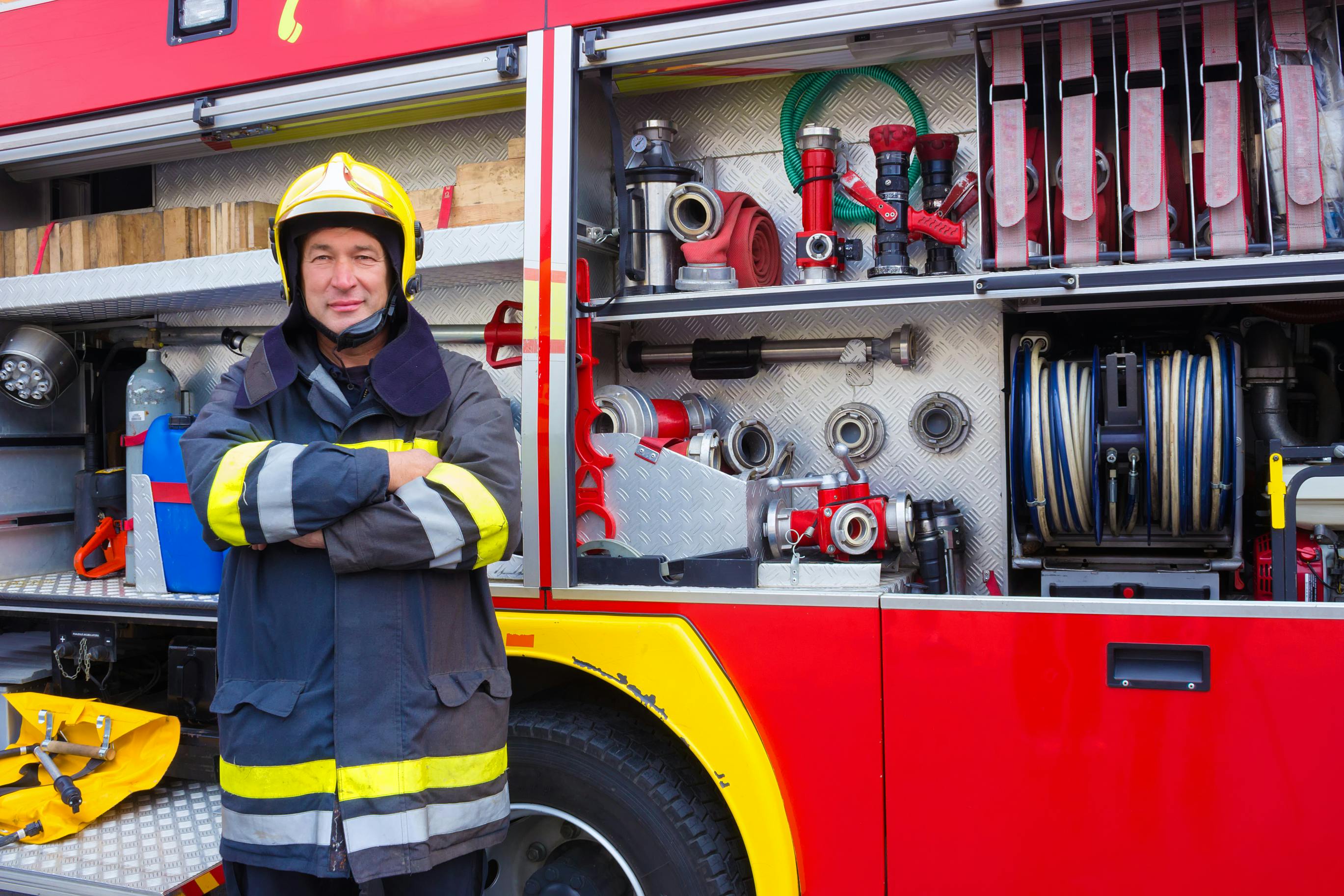 Firefighter standing next to truck