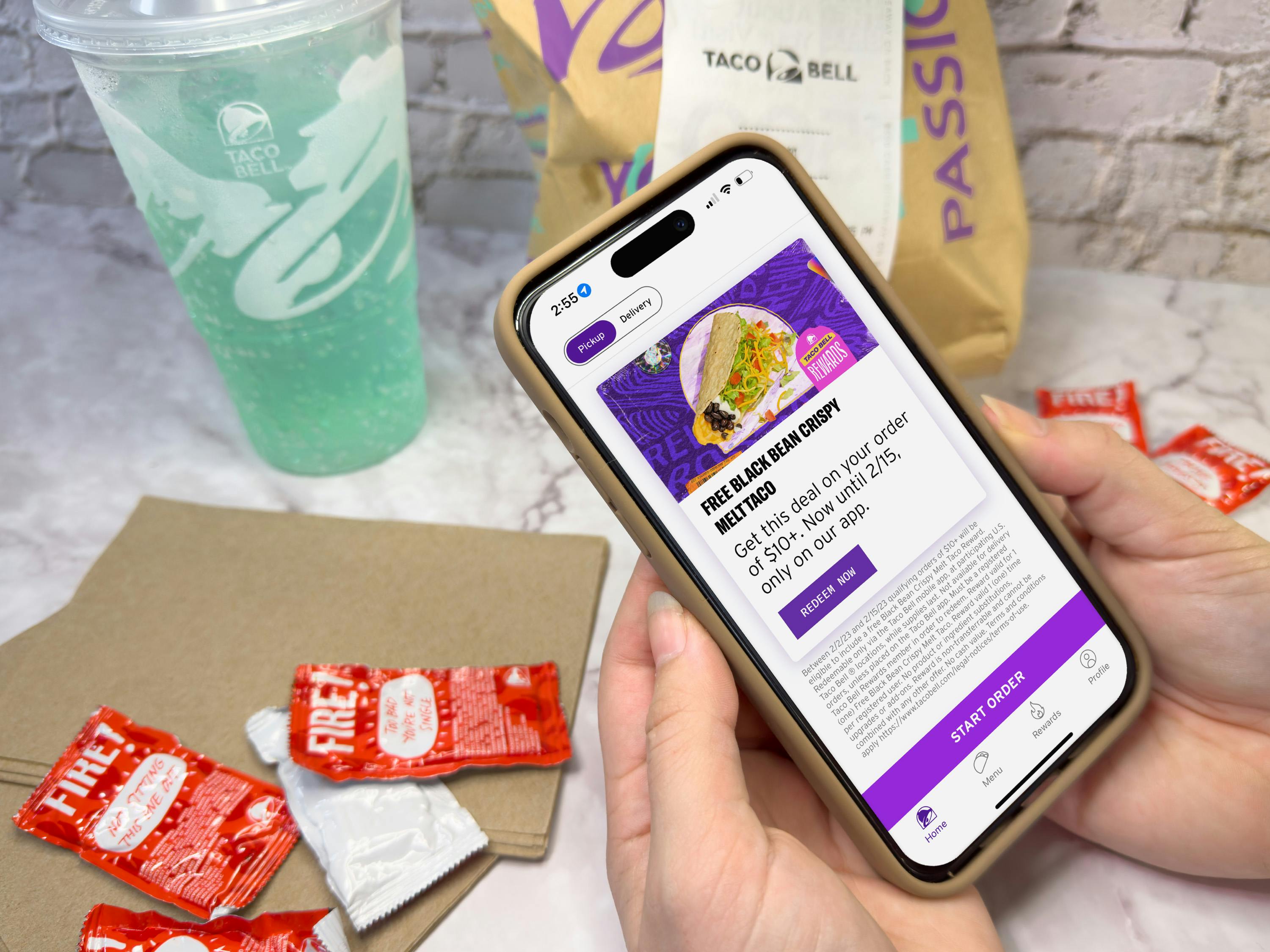 Someone looking at the offer for a free Crispy Melt Taco in the Taco Bell app