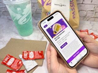 Someone looking at the offer for a free Crispy Melt Taco in the Taco Bell app