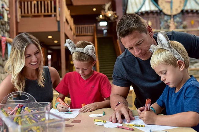 A family doing free lobby crafts together at Great Wolf Lodge