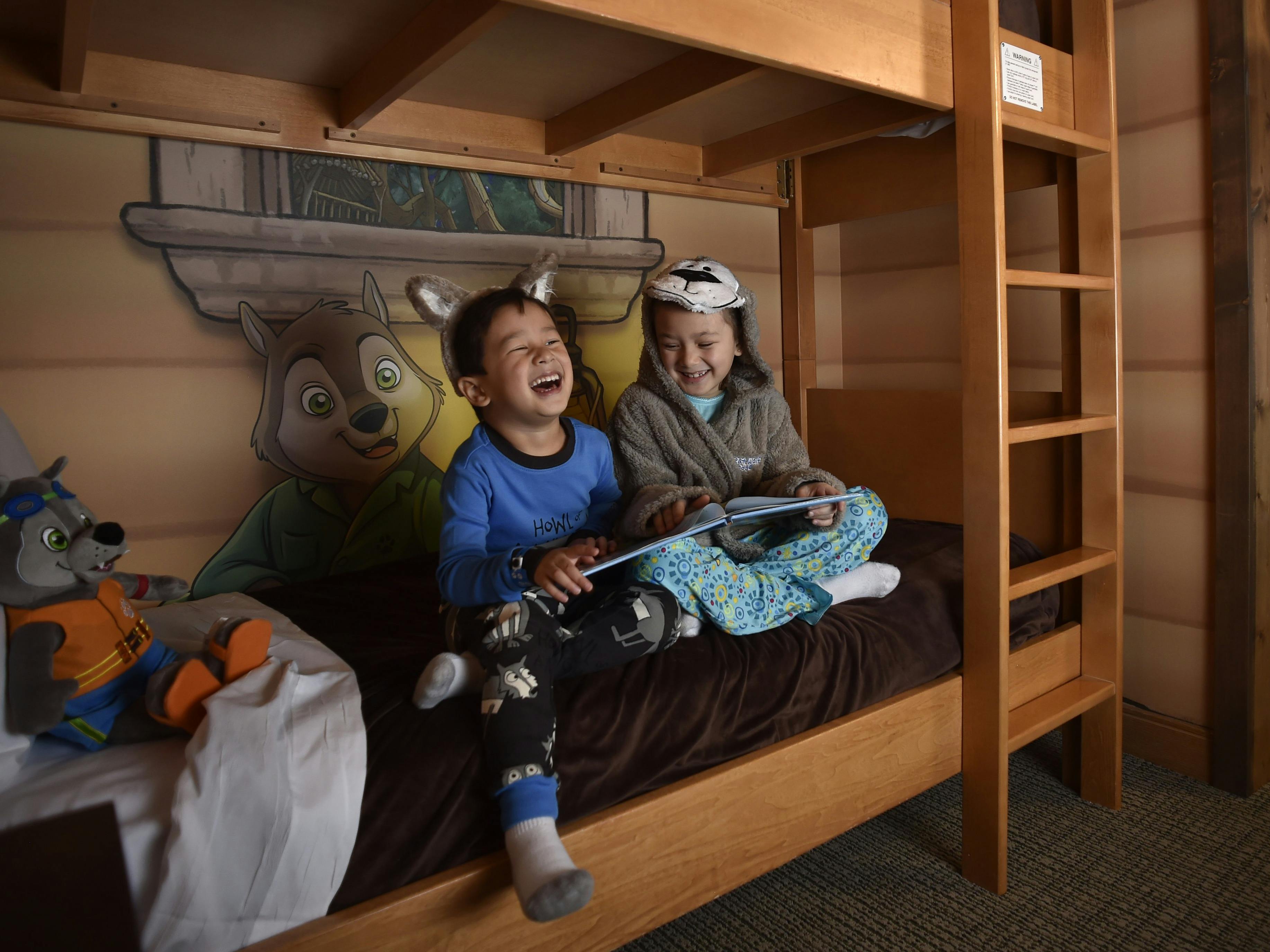 Two children sitting on the bottom bunk bed in a guest room at Great Wolf Lodge