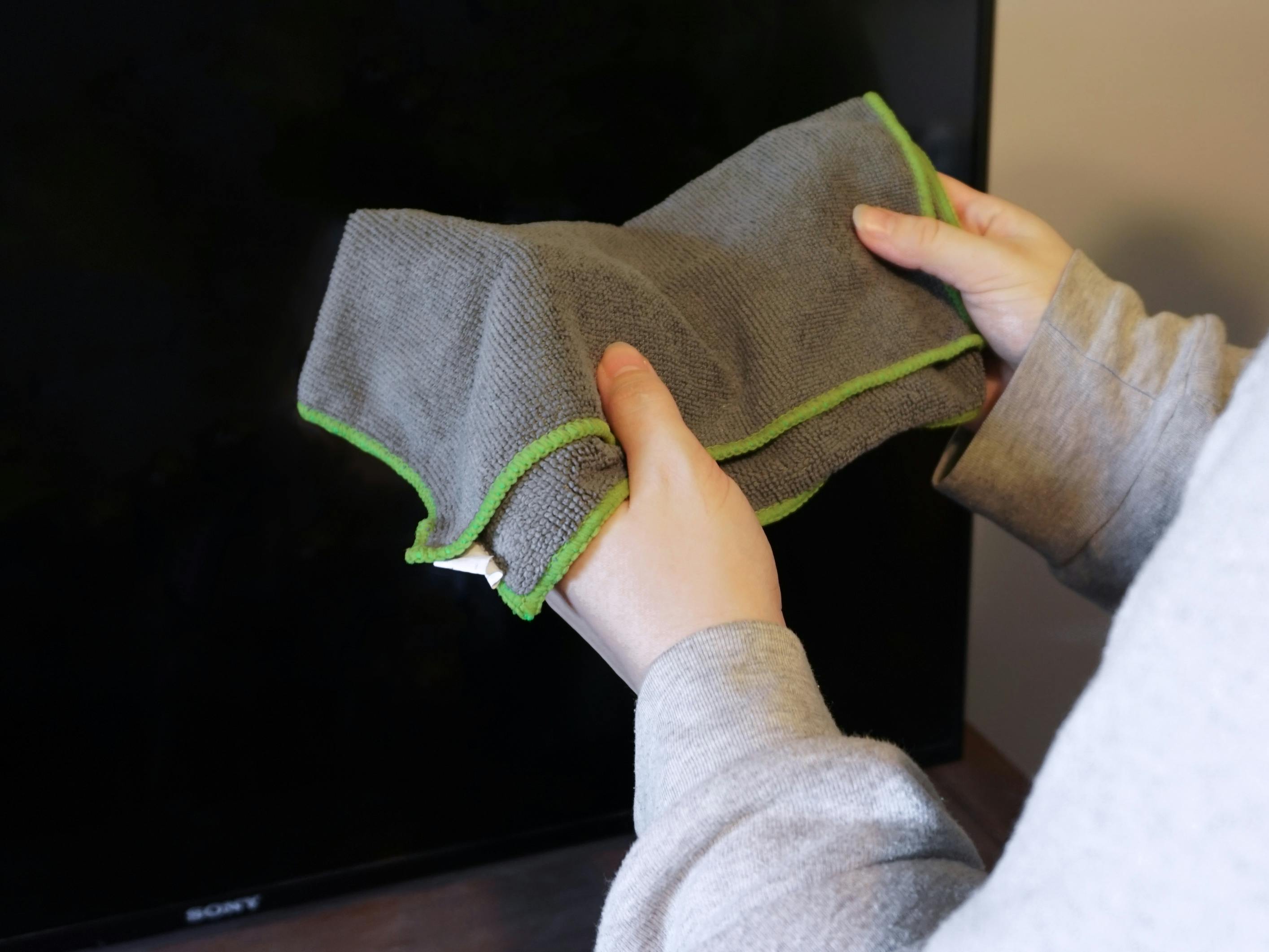 Someone holding a microfiber cloth, getting ready to clean their TV