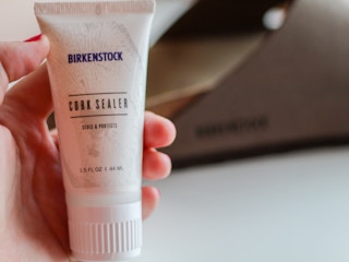 a person holding Birkenstock cork sealer