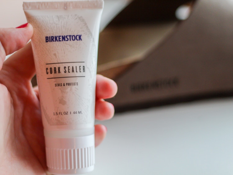 a person holding Birkenstock cork sealer 