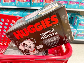 A box of Huggies Special Delivery diapers sitting in a store cart.