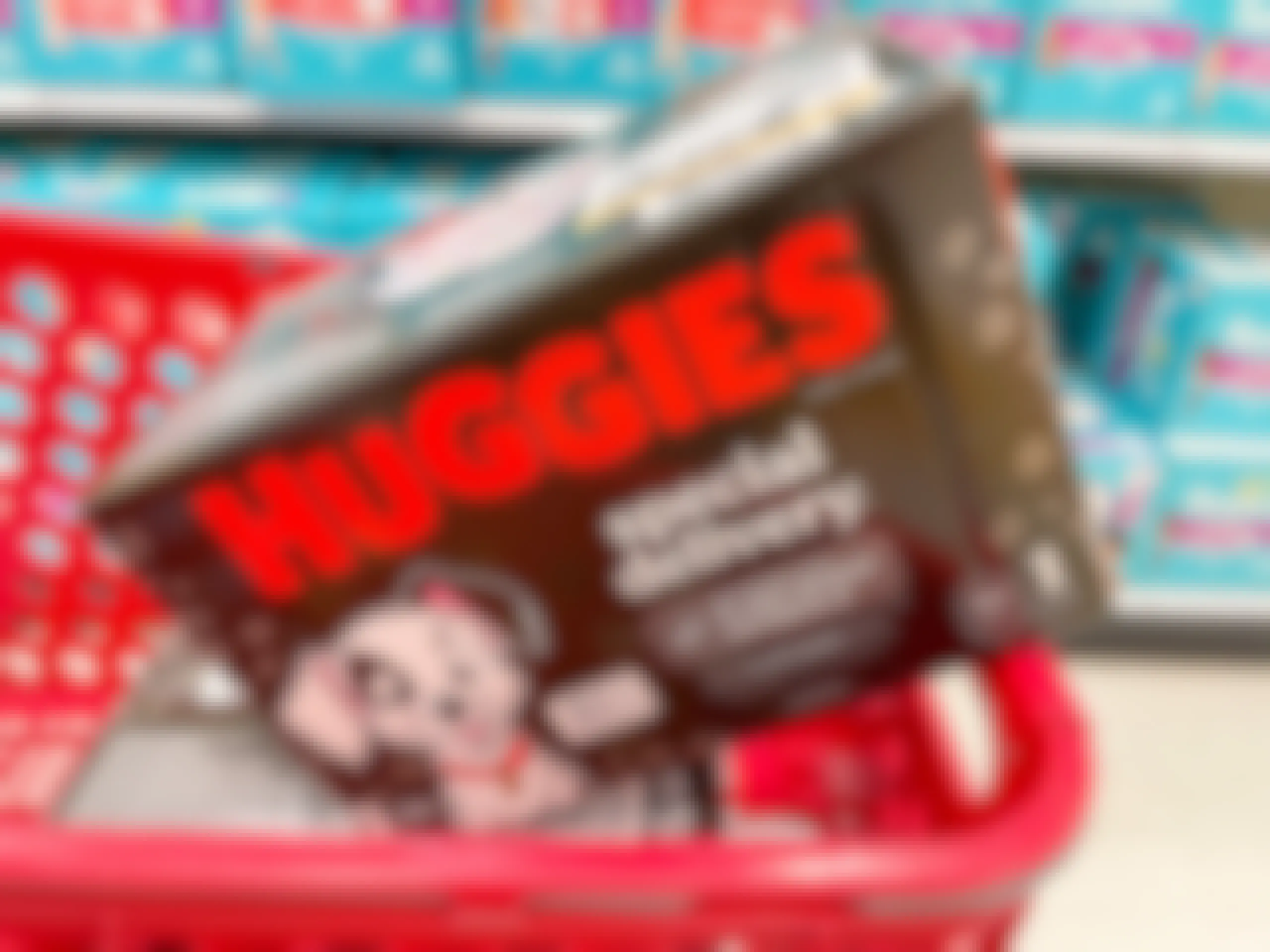 A box of Huggies Special Delivery diapers sitting in a store cart.