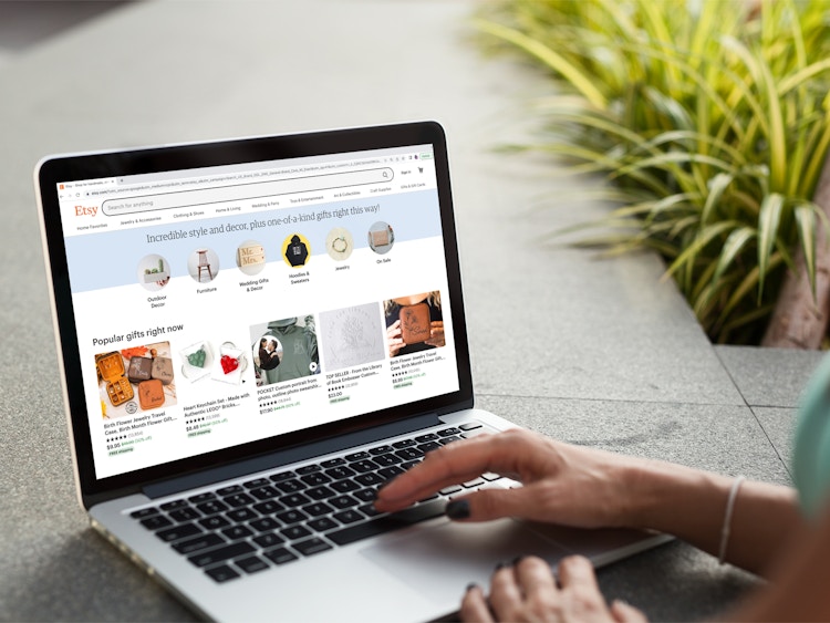 a person looking at the etsy website on their macbook
