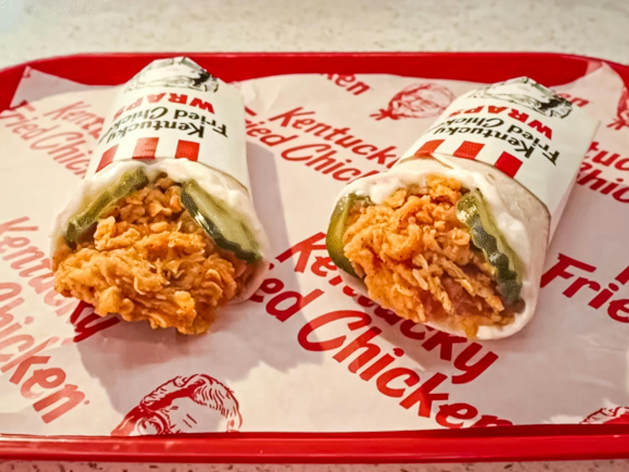 Two KFC wraps on a tray