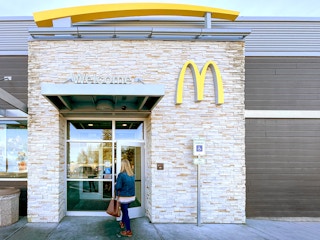 woman walking into mcdonalds restaurant