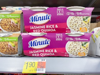 A couple one minute rice packages sitting on a store shelf.