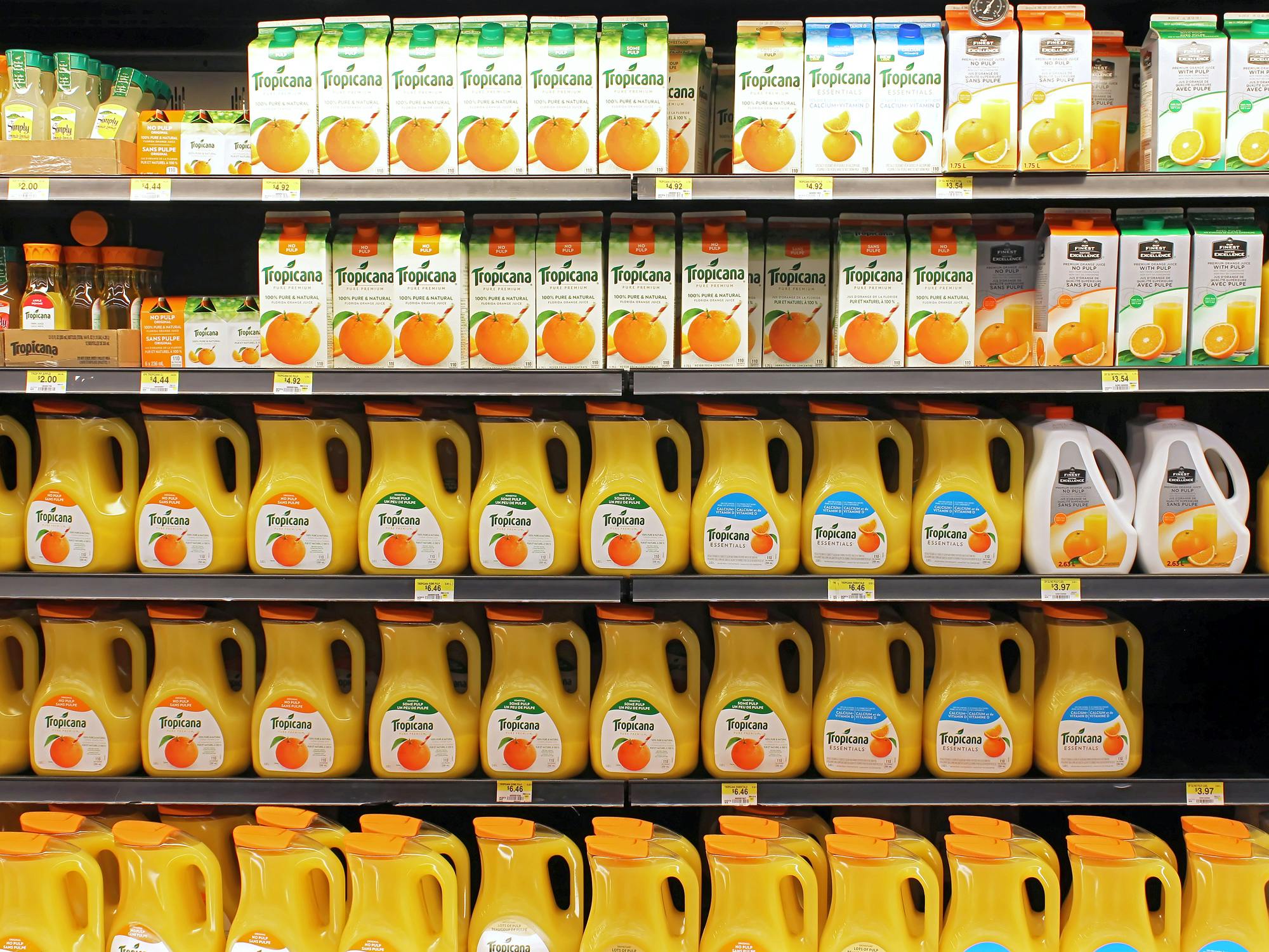 tropicana and simply orange juice bottles on store shelves