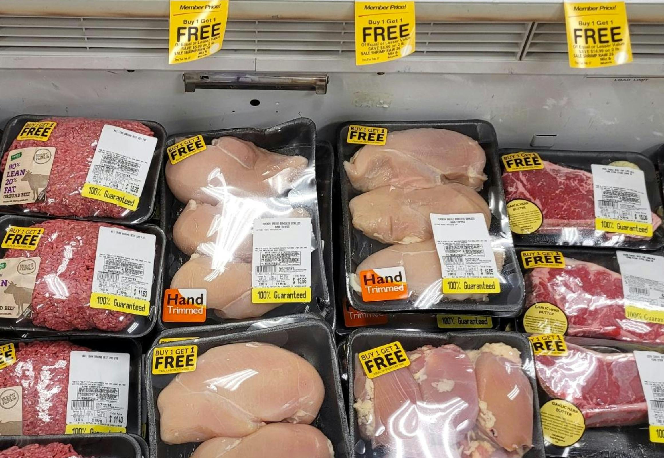 Chicken breast packages in a store fridge