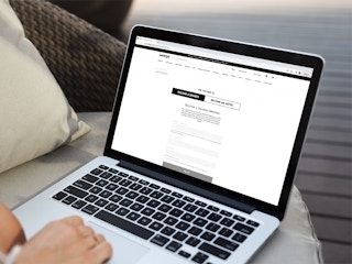 a person looking at the society 6 website on their macbook