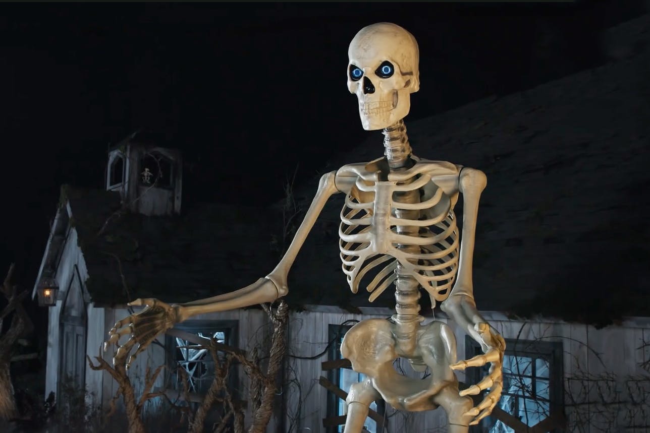 The giant skeleton from Home Depot on a spooky Halloween set